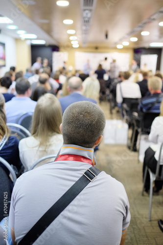 The audience listens to the acting in a conference hall