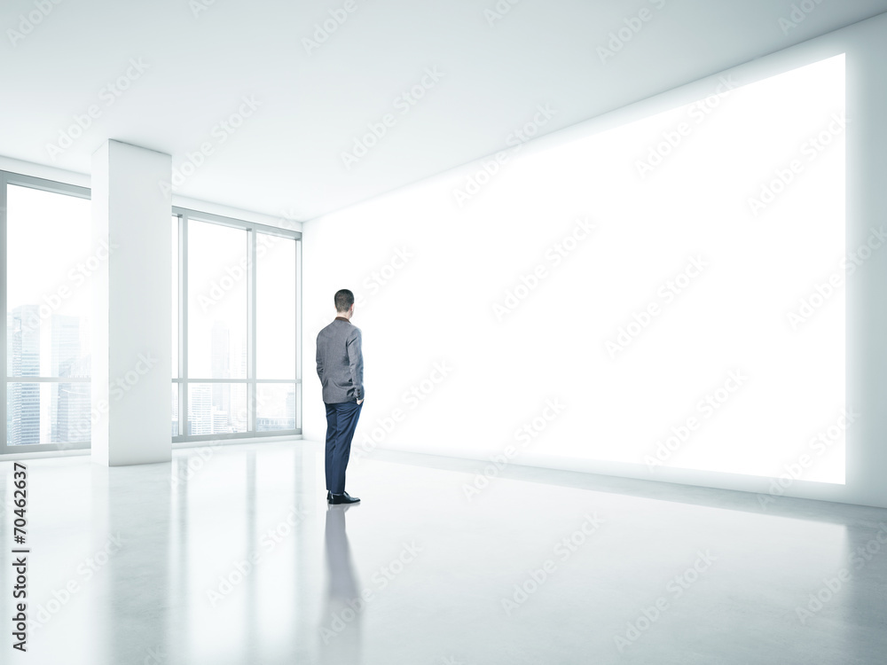Man looking at white panel Man looking at white panel