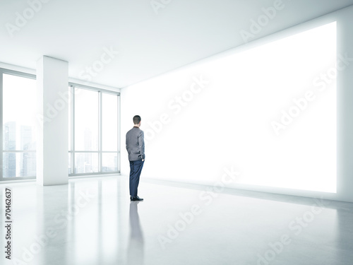 Man looking at white panel