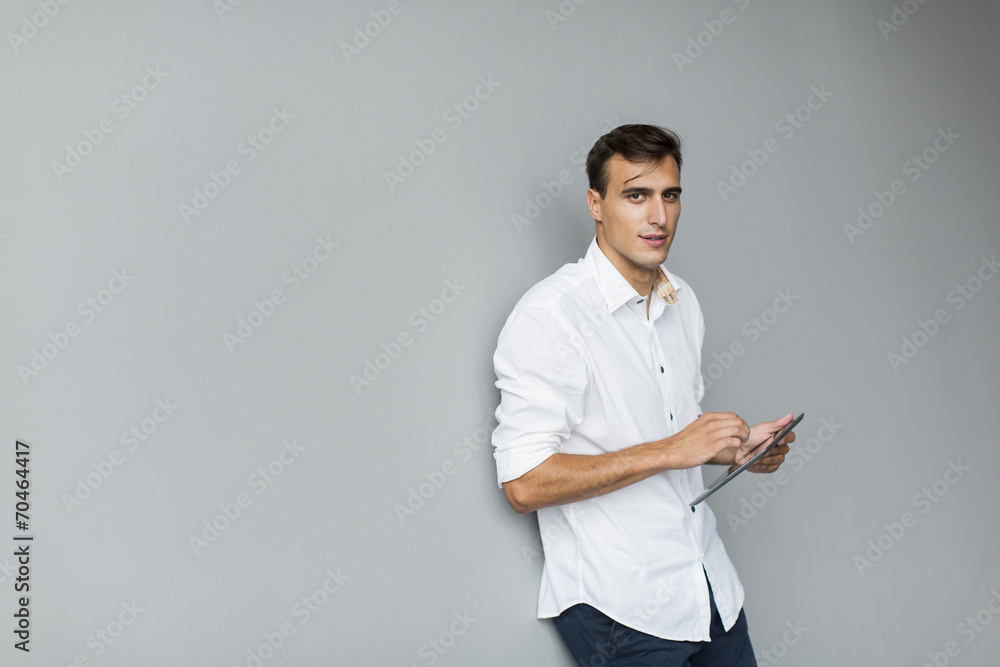 Man with tablet by the wall Man with tablet by the wall