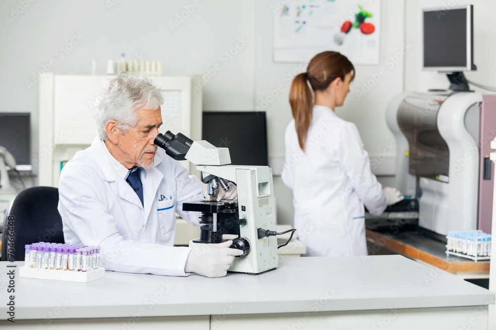 Male Scientist Using Microscope In Lab Male Scientist Using Microscope In Lab