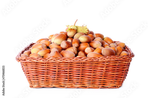 Heap hazelnut in basket isolated on white