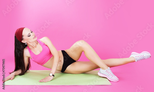 Gymnastics. Abdominal Exercise. Shapely Woman on a Sport Mat