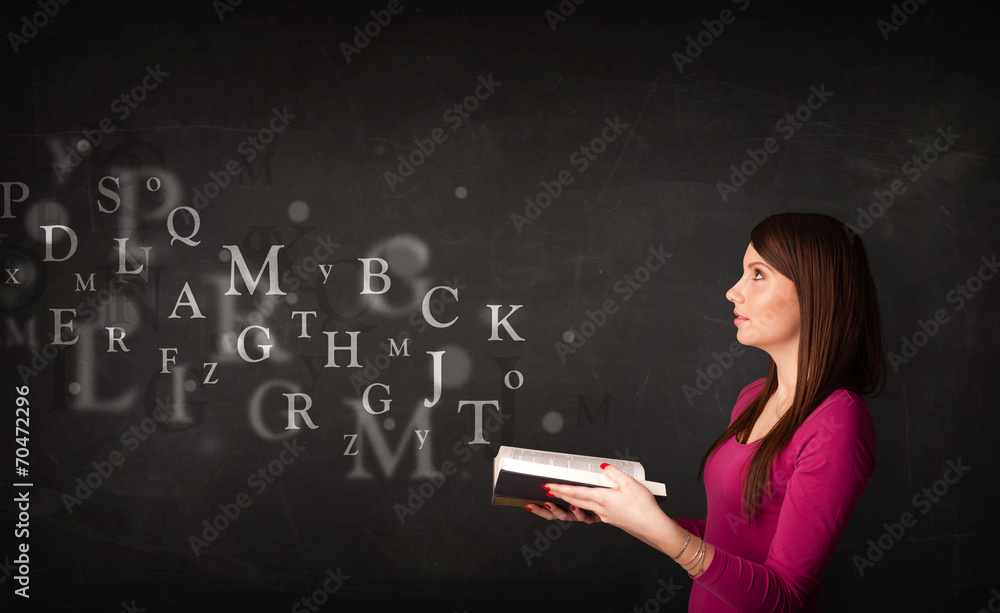 Young lady reading a book with alphabet letters Young lady reading a book with alphabet letters