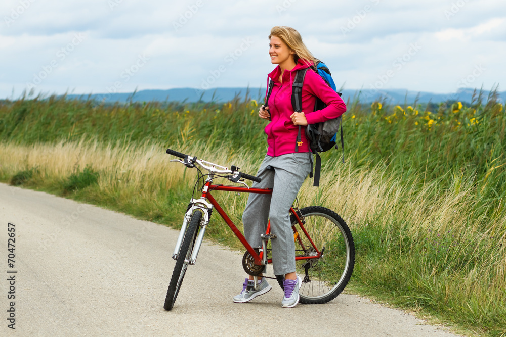 Happy woman on a bike in nature Happy woman on a bike in nature