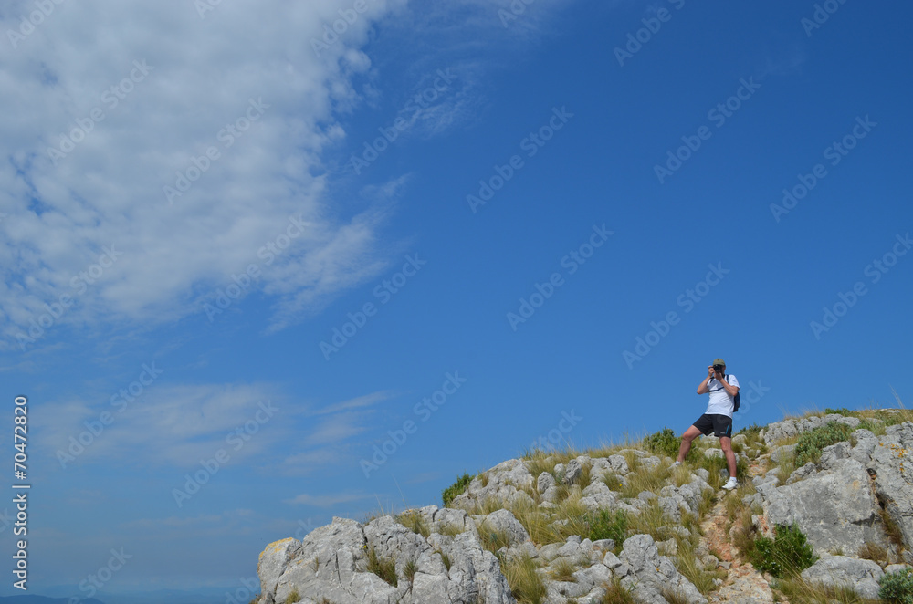 man taking photographs on mountain