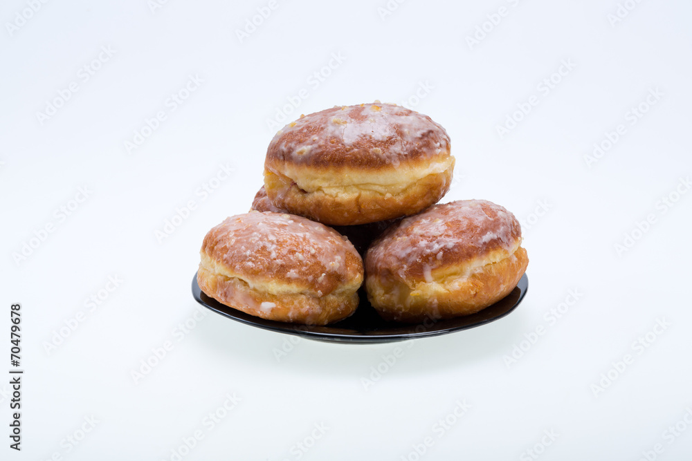 whole donuts on the black porcelain plate