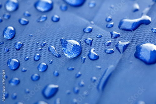 Closeup of rain drops on a blue umbrella photo