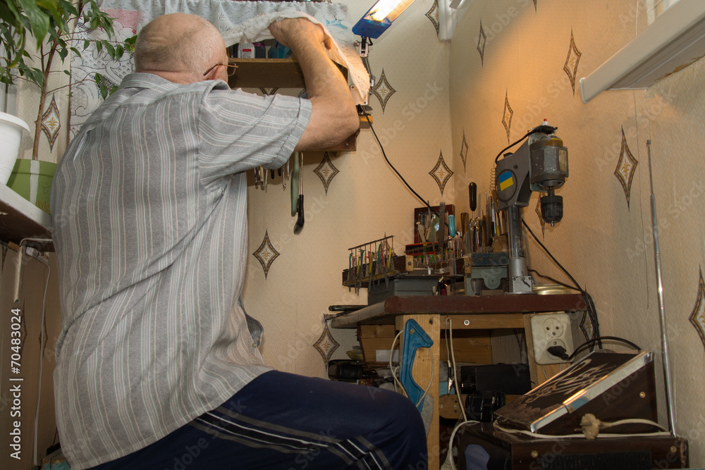 Senior man working at a workbench