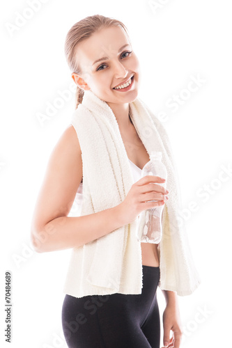 Woman with bottle of water and towel. Fitness wear