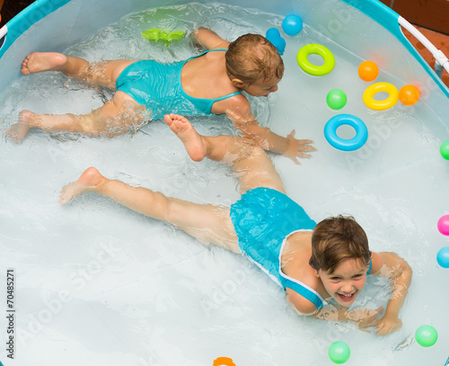 Children swimming in kid pool photo