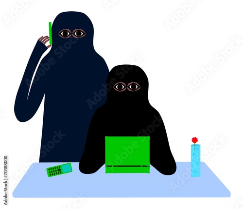 Two muslim women at a table with a cell phone and laptop