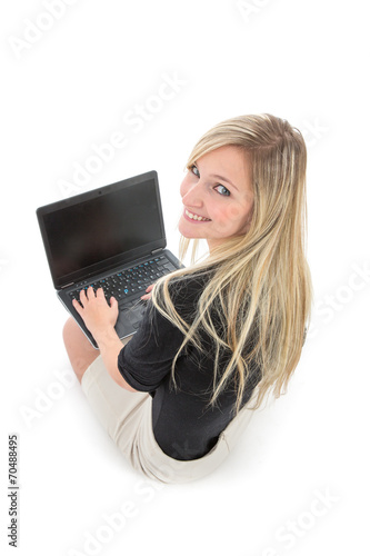 Woman with Laptop Smiling Over Shoulder at Camera