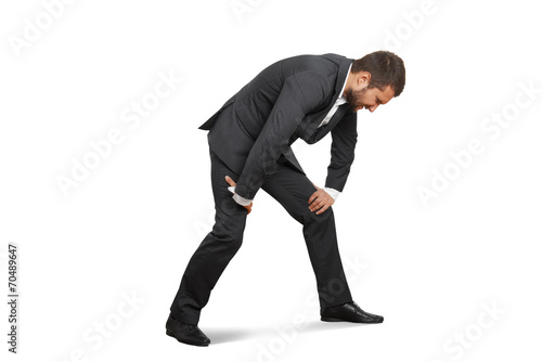 tired businessman doubled over