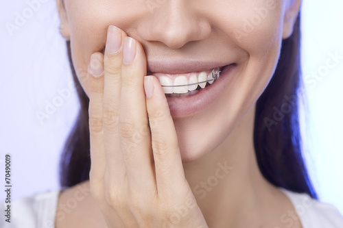 Portrait of Beautiful smiling girl covering her retainer for tee