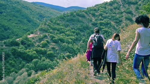 Family hiking on a mountain path  photo