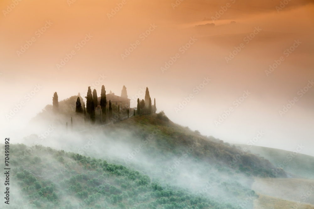 Amazing foggy sunrise in countryside of Tuscany, Italy