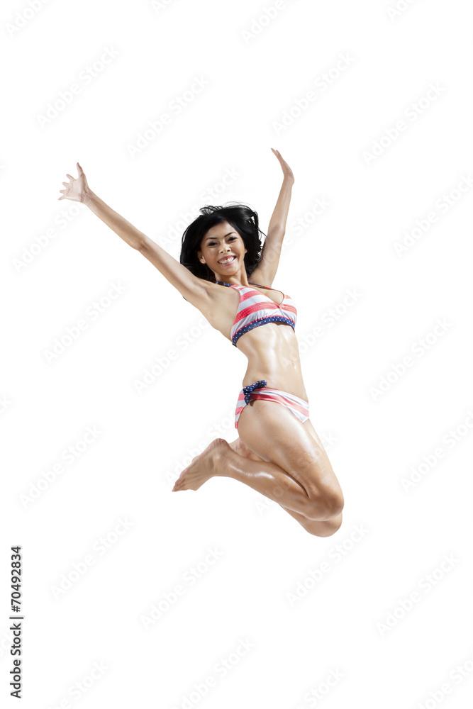 Joyful woman wearing swimwear jumping isolated Joyful woman wearing swimwear jumping isolated