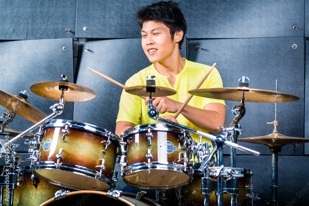 Fototapeta premium Asian musician drummer in recording studio