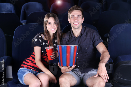 Young couple watching movie...