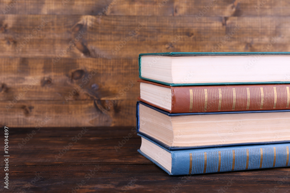 Books on wooden table on wooden wall background Books on wooden table on wooden wall background