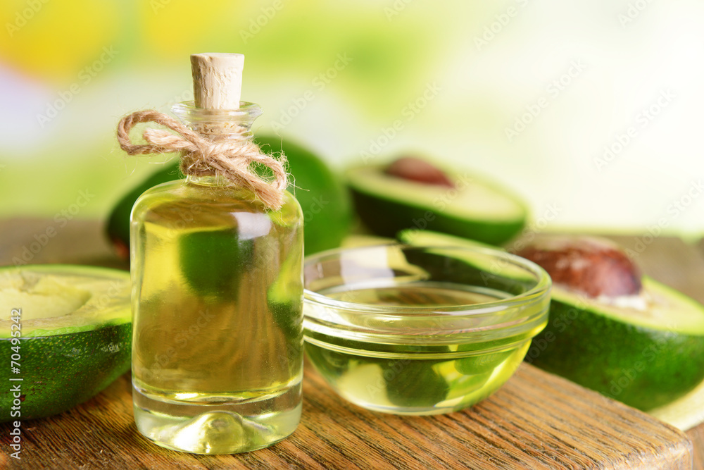 Avocado oil on table on light background Avocado oil on table on light background