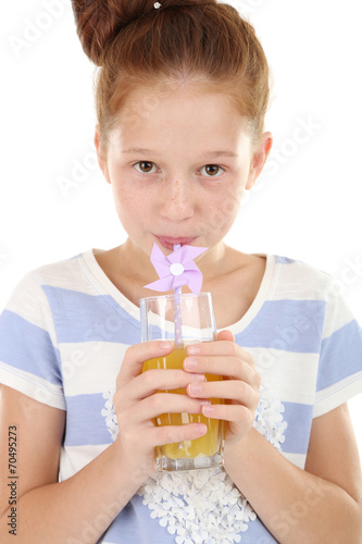 Beautiful little girl holding glass of juice close up