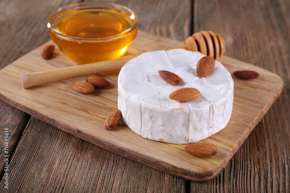 Camembert cheese, nuts and honey in glass bowl Camembert cheese, nuts and honey in glass bowl