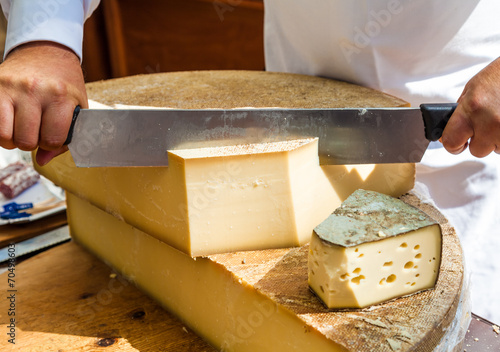 Man cutting piece of cheese