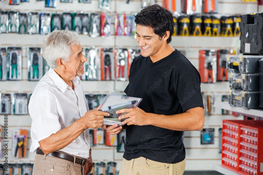 Father And Son Buying Drill In Store
