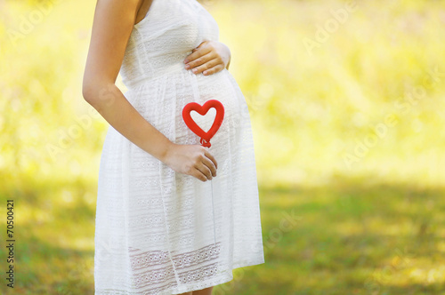 Pregnancy, maternity, family - concept, pregnant woman and heart