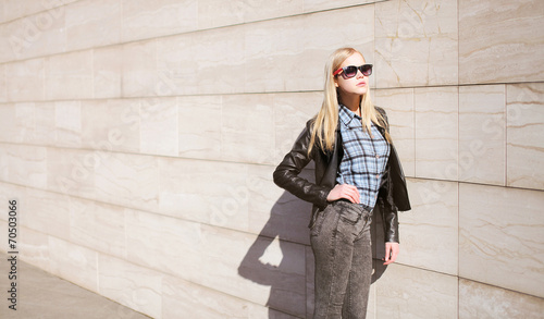 Street fashion, stylish young girl in leather jacket and sunglas