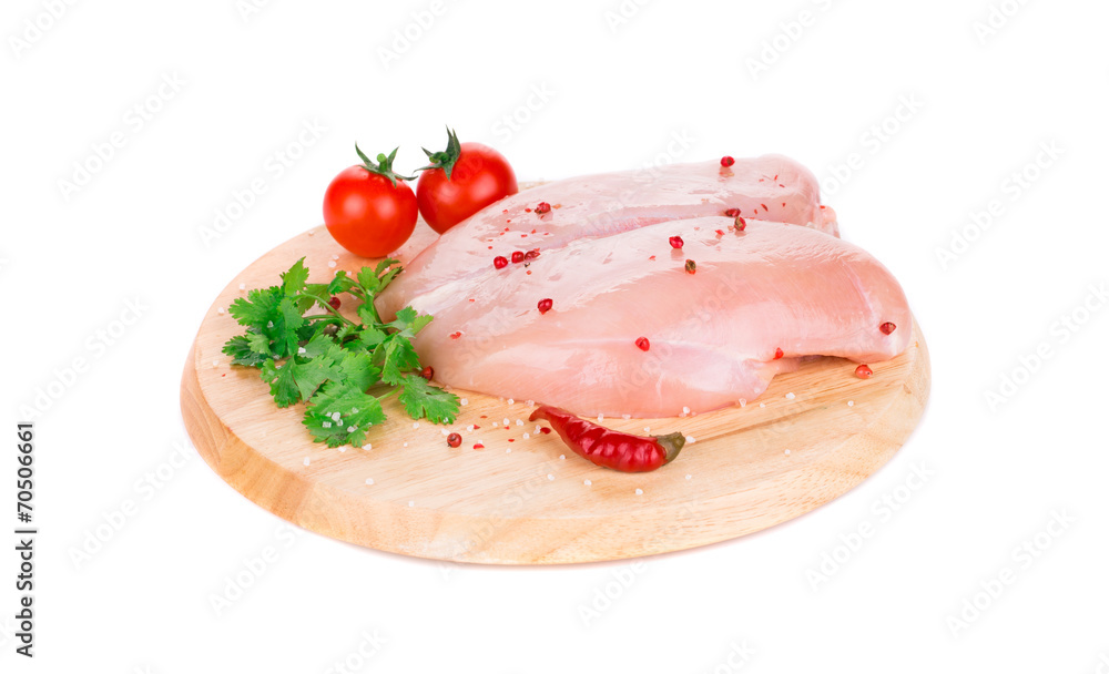 Raw chicken breast on wooden platter. Raw chicken breast on wooden platter.