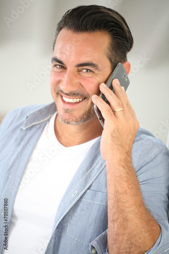 Smiling mature man talking on mobile phone