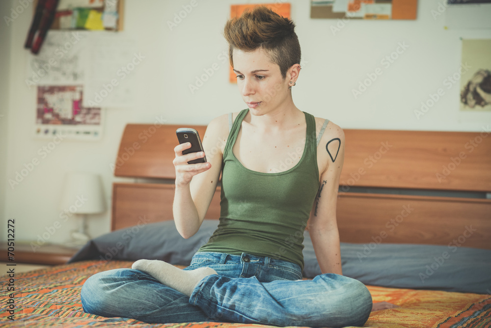 young lesbian stylish hair style woman using smart phone young lesbian stylish hair style woman using smart phone