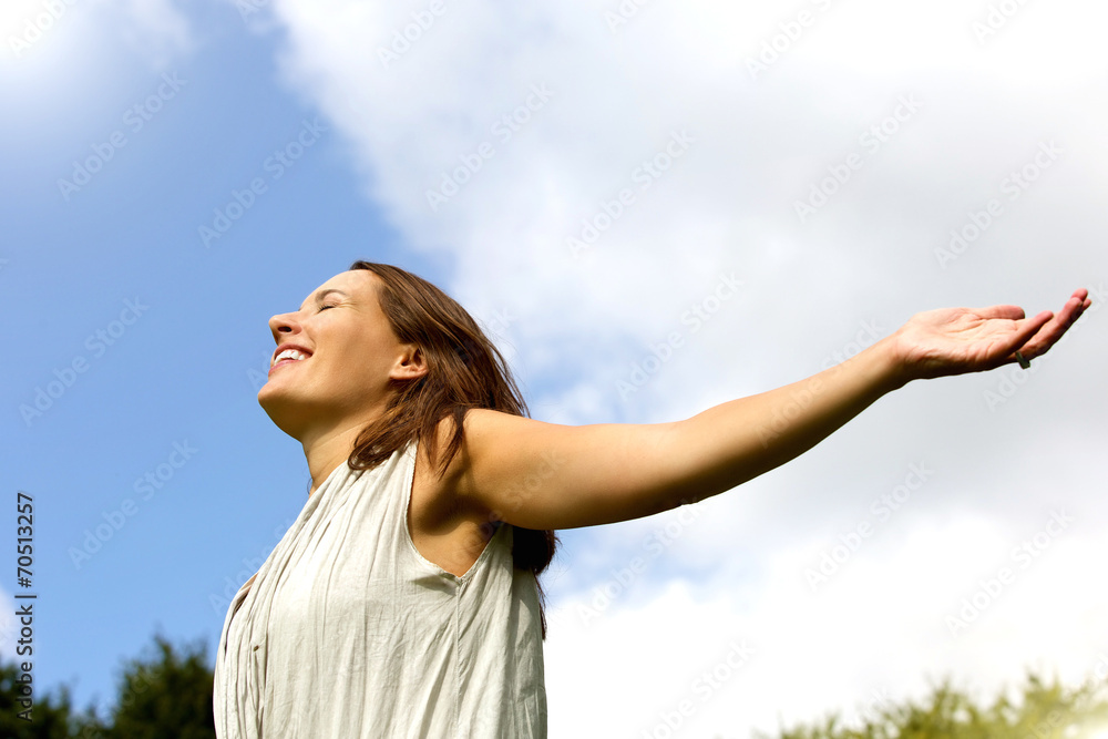 Carefree woman smiling with arms spread open Carefree woman smiling with arms spread open