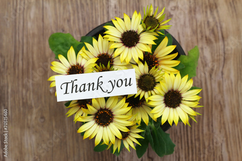 Thank you card with yellow daisies on wooden surface