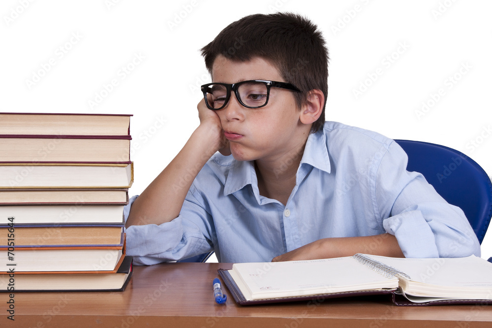 child at the table with books from school child at the table with books from school