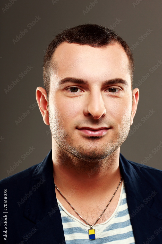 Fototapeta premium Portrait of a handsome man on gray background
