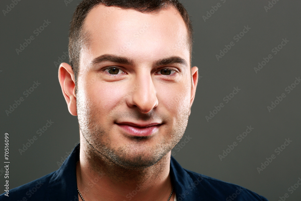 Closeup portrait of happy man on gray background Closeup portrait of happy man on gray background