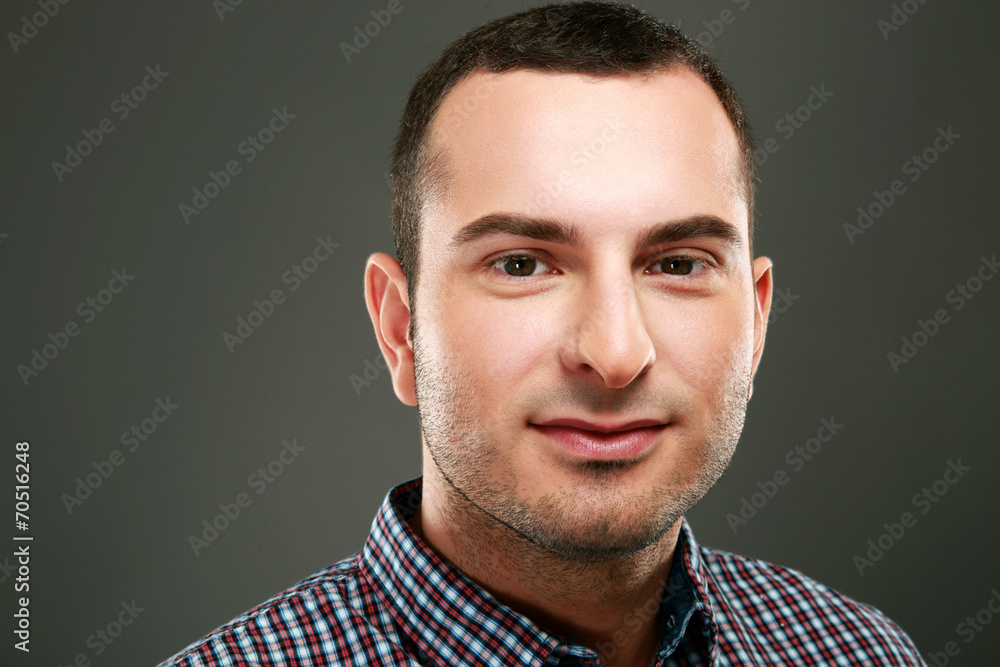 Fototapeta premium Closeup portrait of happy man on gray background
