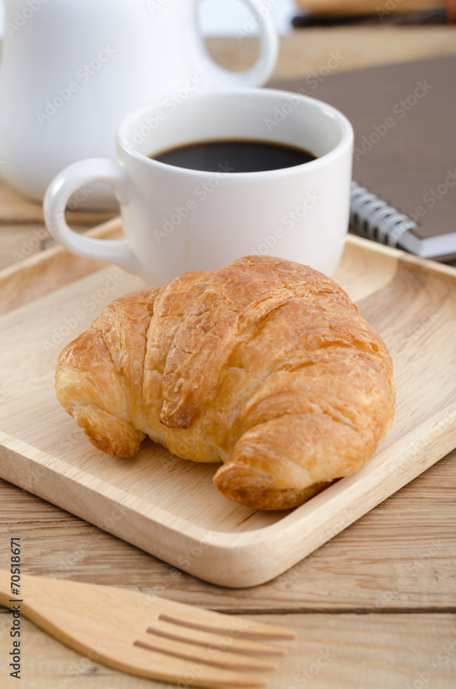 Black coffee with croissants on the wooden tray Black coffee with croissants on the wooden tray
