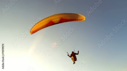 Paragliding over the mountains against blue sky