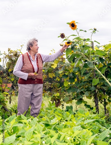 Senior woman holding a sunflower
