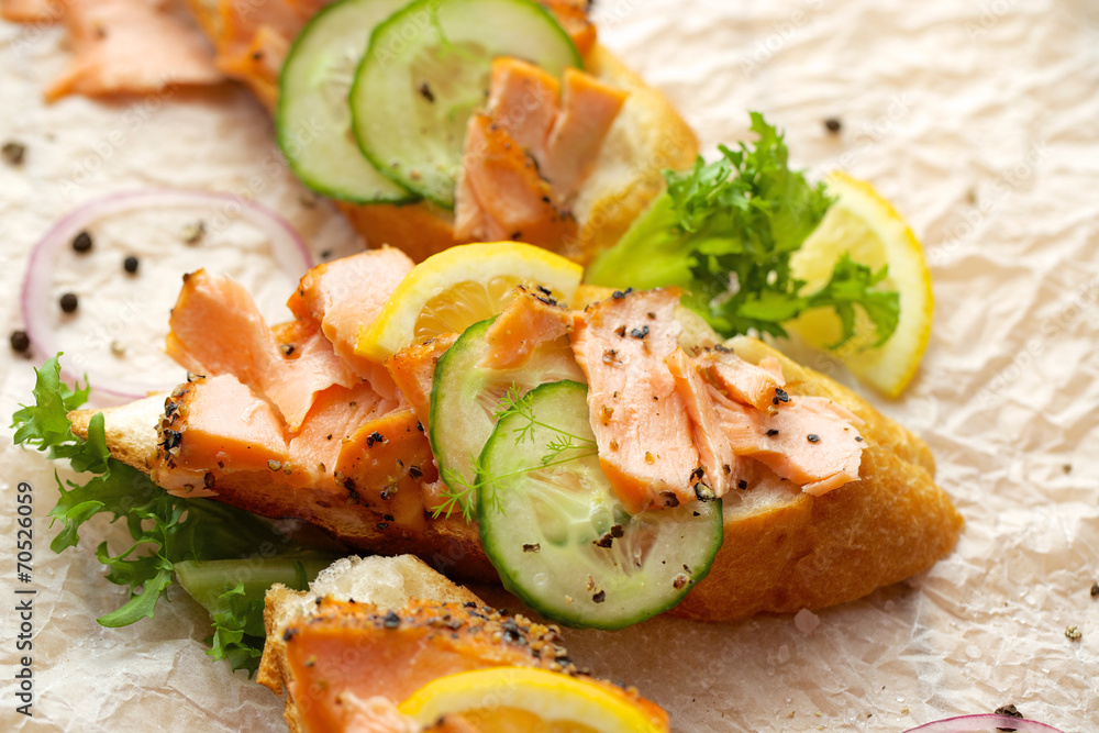 Sandwich with smoked salmon, cucumber, lemon and black pepper