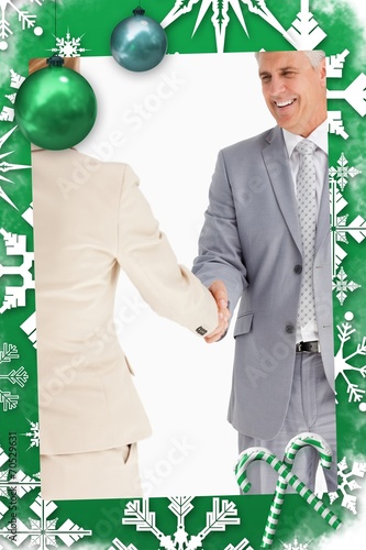 Composite image of happy business people shaking hands photo