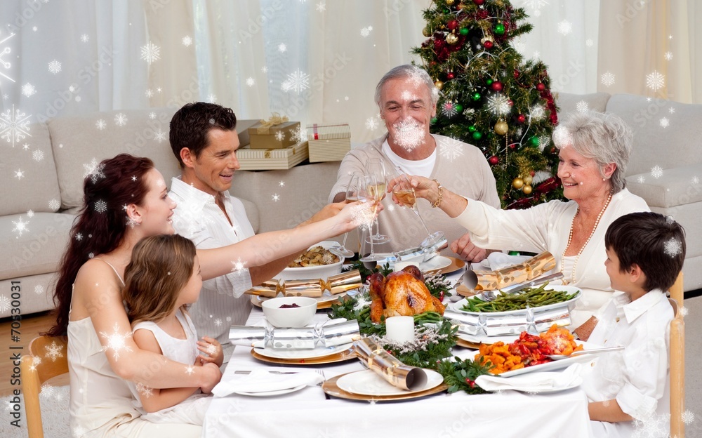 Composite image of family toasting in a christmas dinner