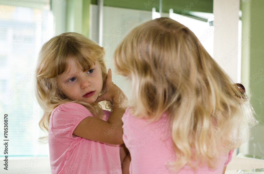 blond girl brushing her hair