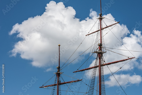 Mast sailing ship on a background of clouds