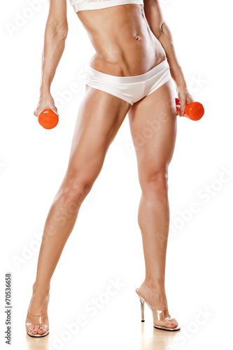 pretty muscular female legs and hands with weights